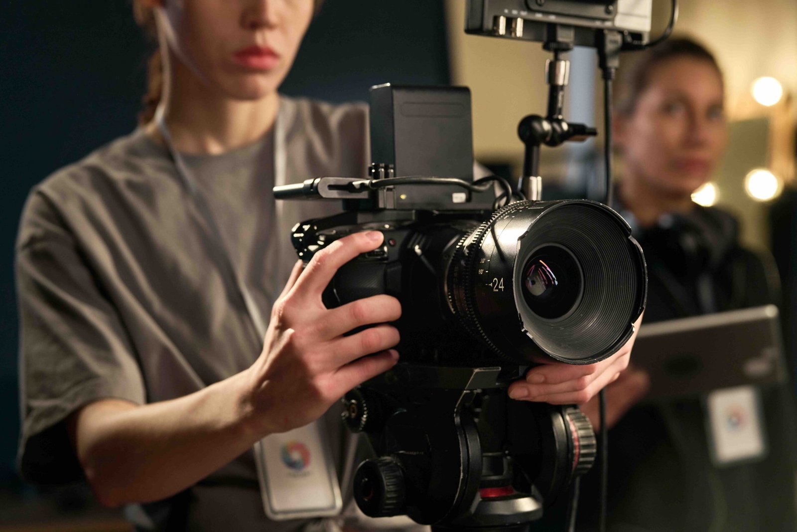 Female Hands Holding Professional Video Camera Close up of female hands holding professional video camera and operating equipment on set copy space