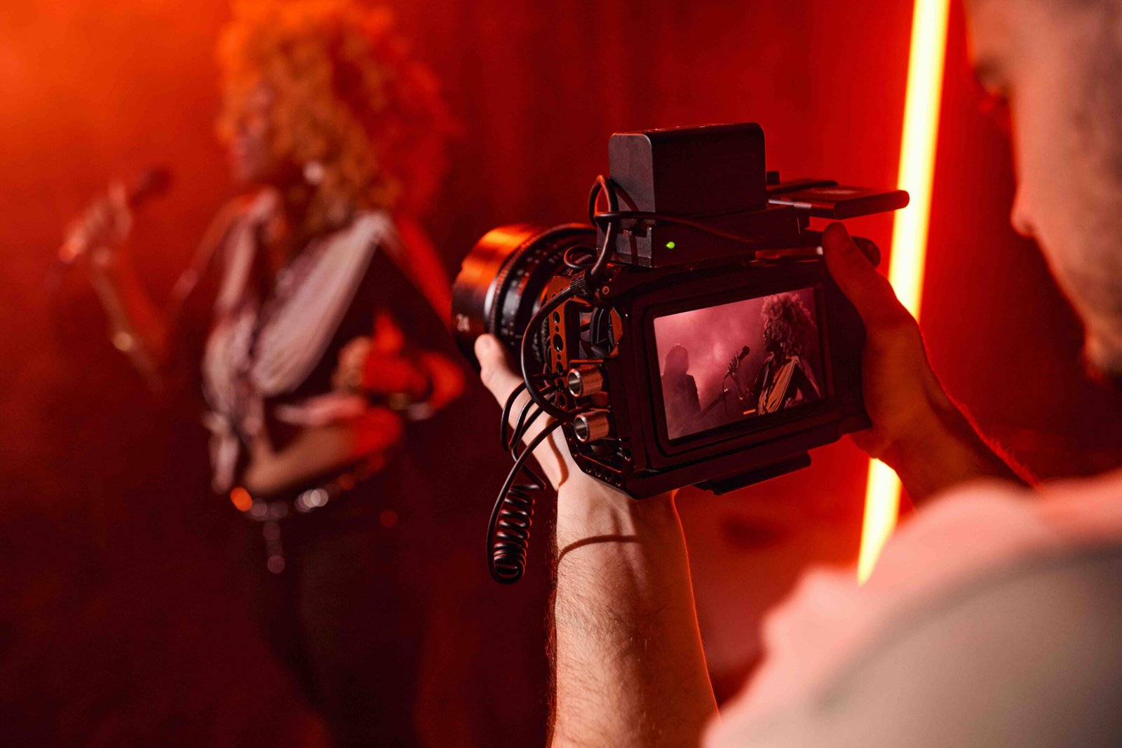Videographer Filming Music Video Close up of unrecognizable videographer holding camera and filming music video for jazz band copy space